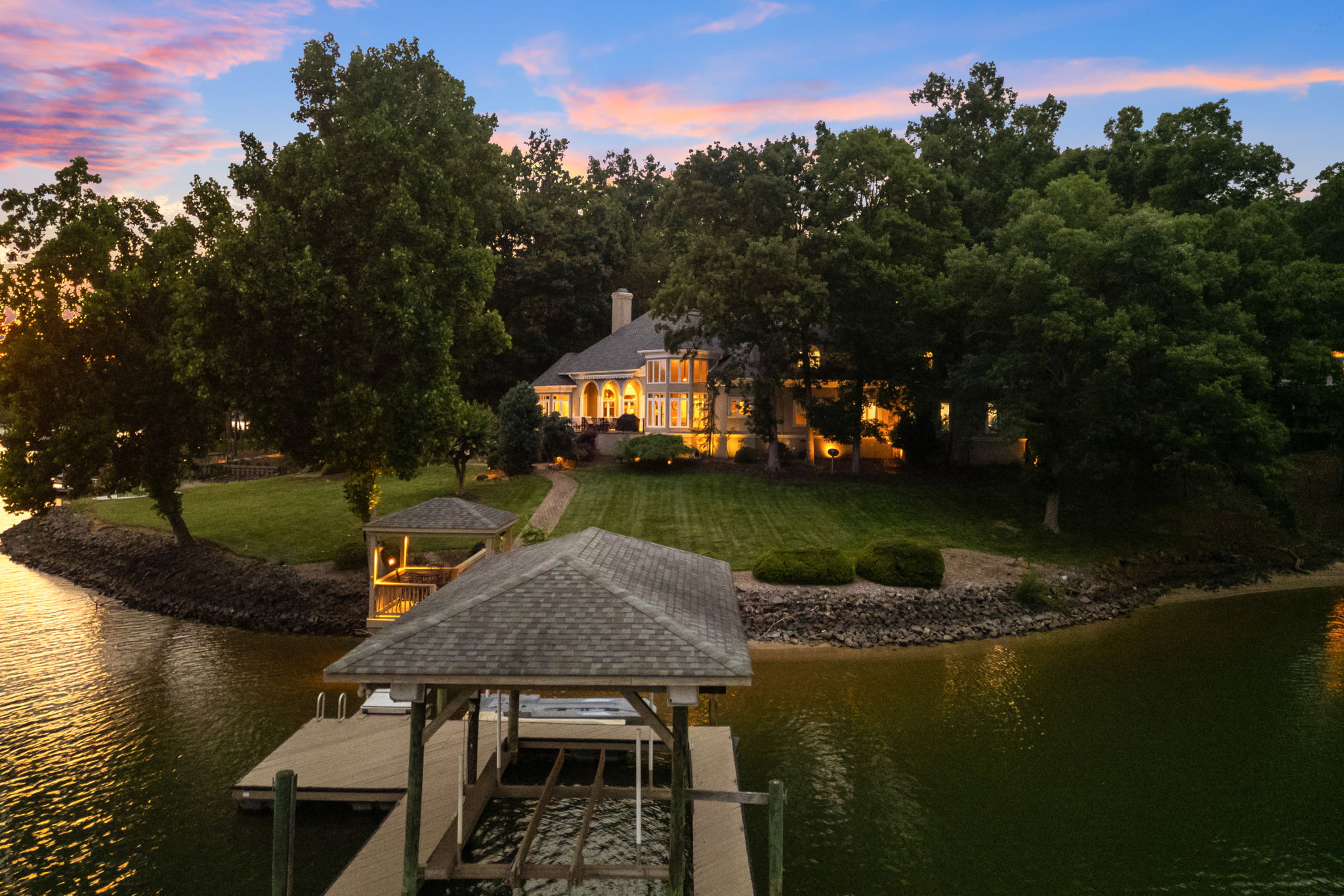 Private covered dock and boat lift on Lake Wylie at twilight